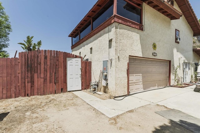 3329 Mandy Ln, Spring Valley, CA 91977 - view of home's exterior with a garage, stucco siding, and driveway