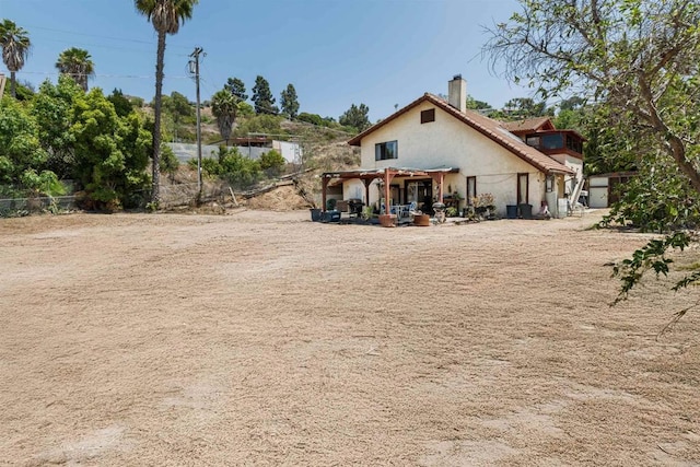 3329 Mandy Ln, Spring Valley, CA 91977 - rear view of house with a chimney and stucco siding