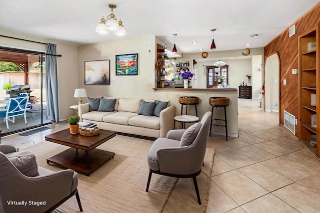 3329 Mandy Ln, Spring Valley, CA 91977 - living room featuring wood walls, light tile patterned flooring, and a chandelier