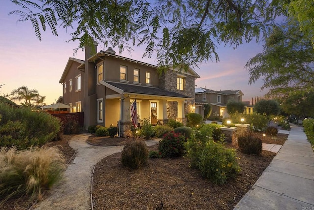 11550 Carowind Ln, Scripps Miramar, CA 92131 - traditional-style home featuring stone siding, stucco siding, a chimney, and a porch
