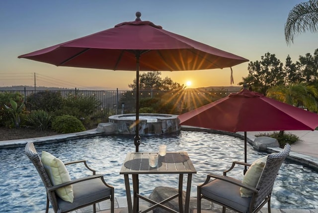 11550 Carowind Ln, Scripps Miramar, CA 92131 - patio terrace at dusk featuring a pool with connected hot tub and a patio area