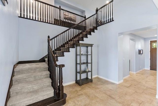 11550 Carowind Ln, Scripps Miramar, CA 92131 - stairway featuring a high ceiling and stone finish flooring