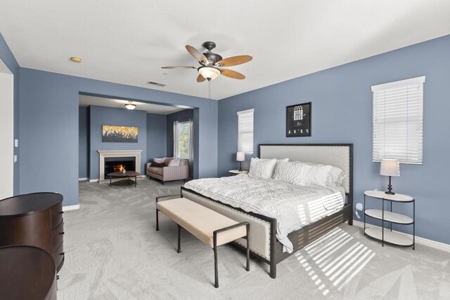11550 Carowind Ln, Scripps Miramar, CA 92131 - bedroom with carpet floors, a warm lit fireplace, and ceiling fan