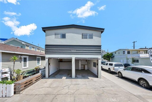 300 34th St, Newport Beach, CA 92663 - view of front of property featuring stucco siding, a garage, and concrete driveway