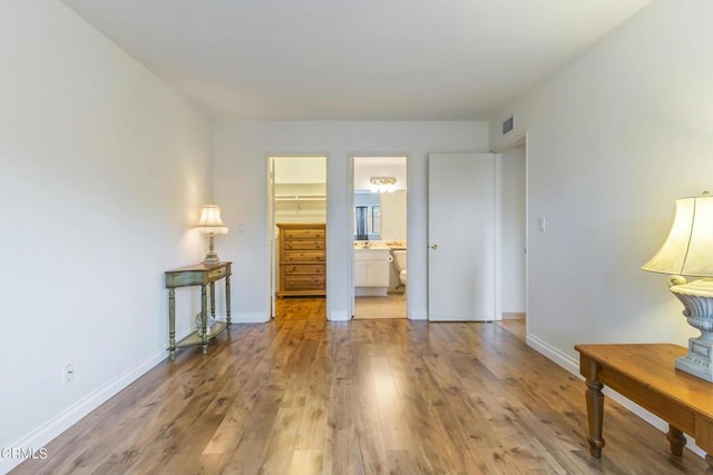 552 Cayo Grande Ct, Newbury Park, CA 91320 - unfurnished bedroom with wood finished floors, a walk in closet, ensuite bath, and a closet