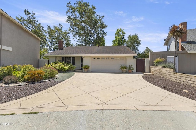 552 Cayo Grande Ct, Newbury Park, CA 91320 - view of front facade featuring an attached garage, concrete driveway, a gate, and a chimney
