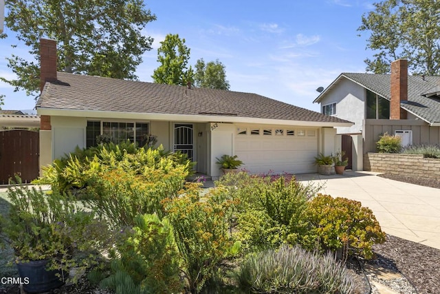 552 Cayo Grande Ct, Newbury Park, CA 91320 - view of front of house with driveway, an attached garage, stucco siding, and a chimney