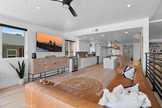 516 S The Strand # A, Oceanside, CA 92054 - living room with beverage cooler, ceiling fan, light wood finished floors, plenty of natural light, and recessed lighting