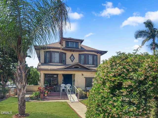 1802 W 49th St, Los Angeles, CA 90062 - view of front facade with stucco siding, a front yard, a porch, and roof with shingles