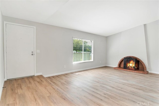 10555 Vassar Ave, Chatsworth, CA 91311 - unfurnished living room with light wood finished floors and a fireplace