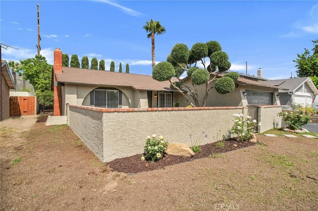 10555 Vassar Ave, Chatsworth, CA 91311 - ranch-style home with a fenced front yard, stucco siding, a chimney, an attached garage, and a gate