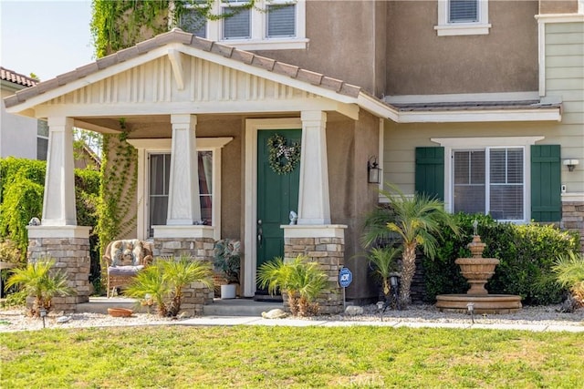 2168 Stonewood St, Mentone, CA 92359 - doorway to property featuring stone siding, a porch, and a yard