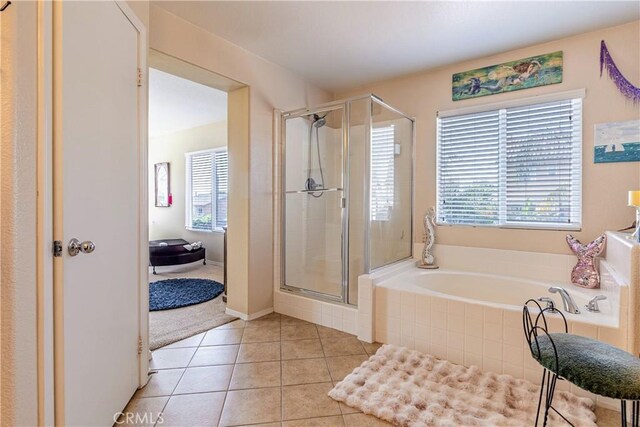 2168 Stonewood St, Mentone, CA 92359 - bathroom with a bath, a shower stall, and tile patterned flooring
