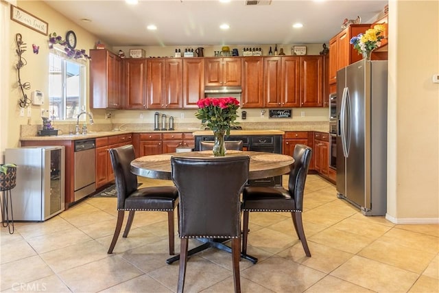2168 Stonewood St, Mentone, CA 92359 - kitchen featuring appliances with stainless steel finishes, light countertops, recessed lighting, beverage cooler, and light tile patterned flooring