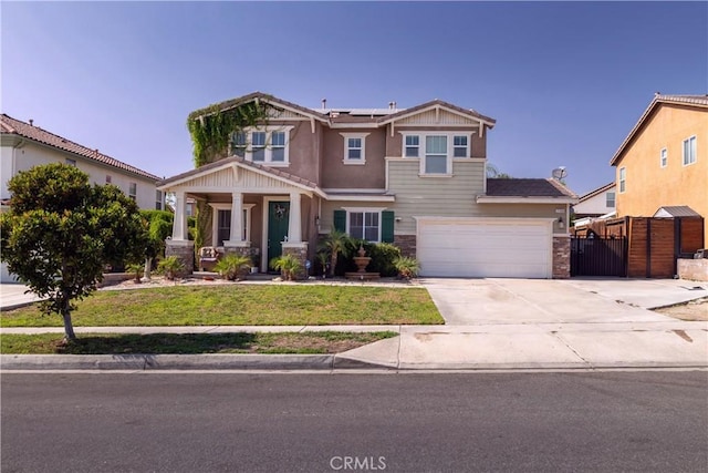 2168 Stonewood St, Mentone, CA 92359 - craftsman inspired home featuring roof mounted solar panels, a gate, driveway, an attached garage, and stone siding