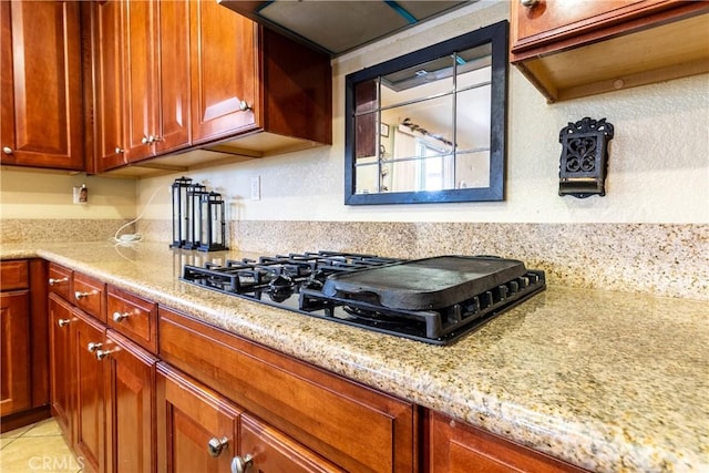 2168 Stonewood St, Mentone, CA 92359 - kitchen featuring black gas cooktop, light stone counters, and ventilation hood