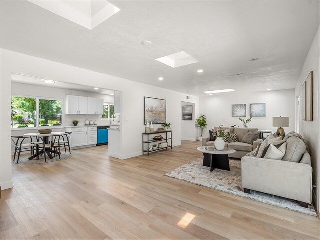 3236 W Browning Ave, Fresno, CA 93711 - living room featuring a skylight, light wood-type flooring, and recessed lighting