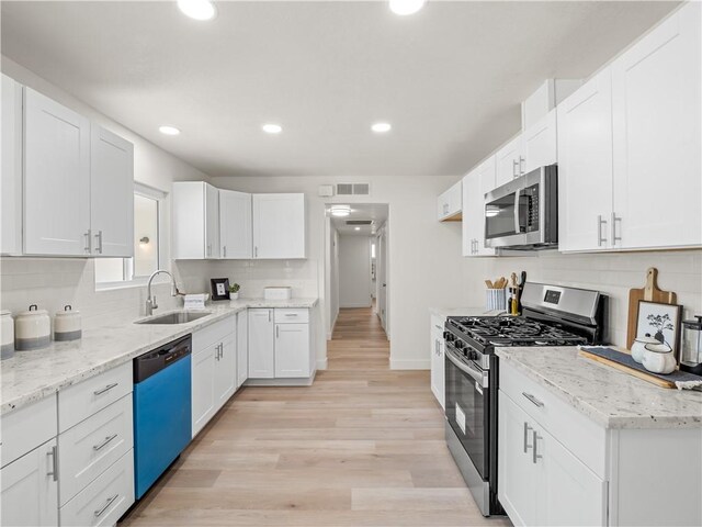 3236 W Browning Ave, Fresno, CA 93711 - kitchen with stainless steel appliances, recessed lighting, tasteful backsplash, and white cabinetry