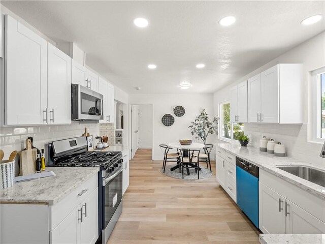 3236 W Browning Ave, Fresno, CA 93711 - kitchen featuring stainless steel appliances, backsplash, white cabinets, recessed lighting, and light wood finished floors