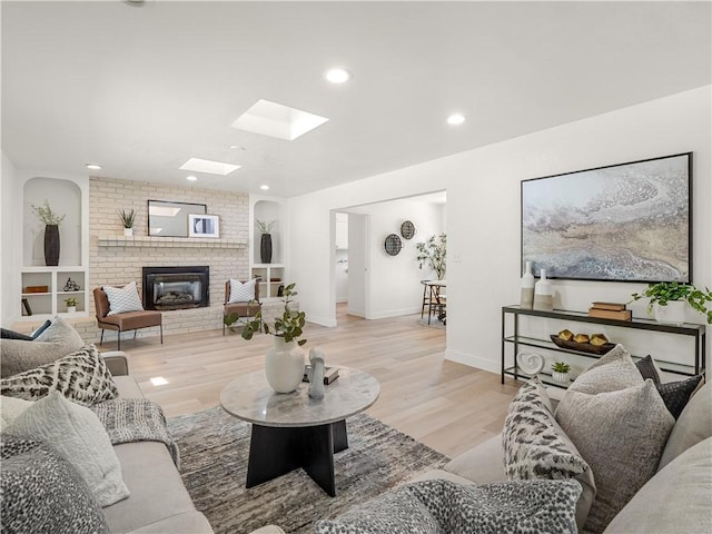 3236 W Browning Ave, Fresno, CA 93711 - living area with a skylight, a brick fireplace, wood finished floors, and recessed lighting