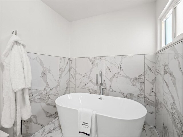 3236 W Browning Ave, Fresno, CA 93711 - full bath with tile walls, marble tiled floors, a freestanding bath, and wainscoting