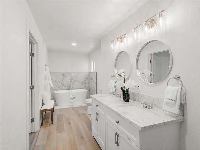 3236 W Browning Ave, Fresno, CA 93711 - bathroom featuring tile walls, double vanity, wood finished floors, and a freestanding bath