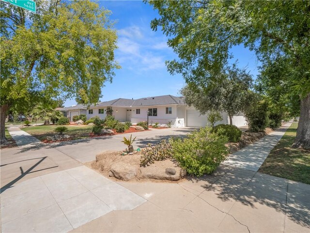 3236 W Browning Ave, Fresno, CA 93711 - ranch-style house with driveway, a garage, and stucco siding