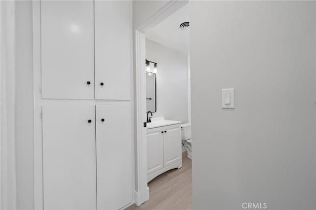 503 Saint Andrews Rd Unit E, Newport Beach, CA 92663 - hall with light wood-style floors and a sink