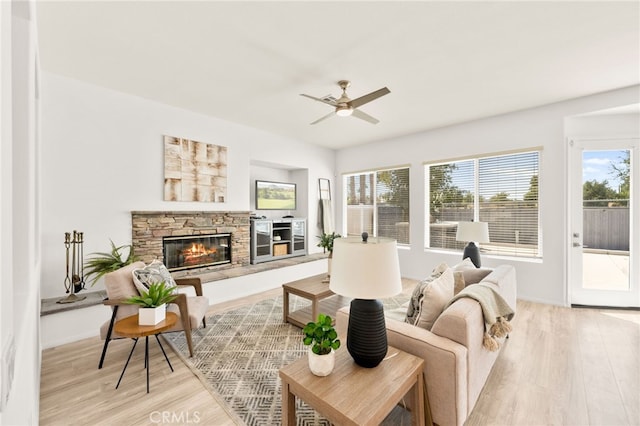 40065 Temple Ct, Murrieta, CA 92563 - living room with light wood finished floors, a ceiling fan, plenty of natural light, and a fireplace