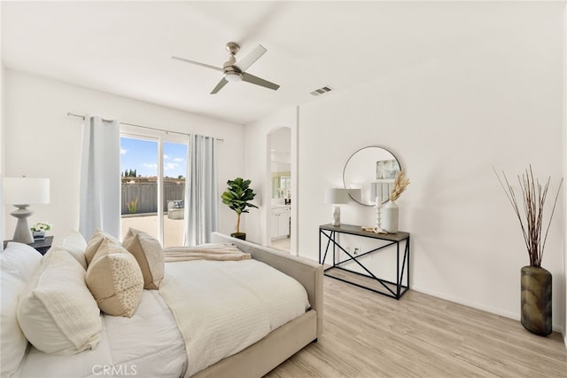 40065 Temple Ct, Murrieta, CA 92563 - bedroom with arched walkways, light wood-type flooring, connected bathroom, and ceiling fan