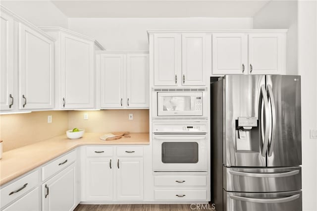 40065 Temple Ct, Murrieta, CA 92563 - kitchen featuring white appliances, white cabinets, and light countertops