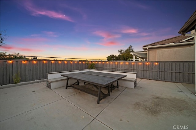 40065 Temple Ct, Murrieta, CA 92563 - patio terrace at dusk featuring a patio and a fenced backyard