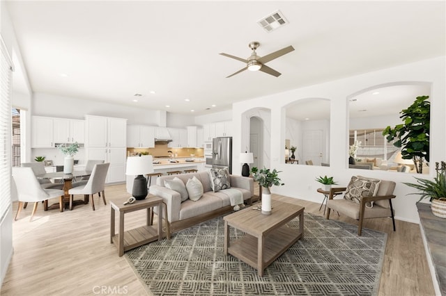 40065 Temple Ct, Murrieta, CA 92563 - living area featuring a ceiling fan, light wood-style flooring, and arched walkways