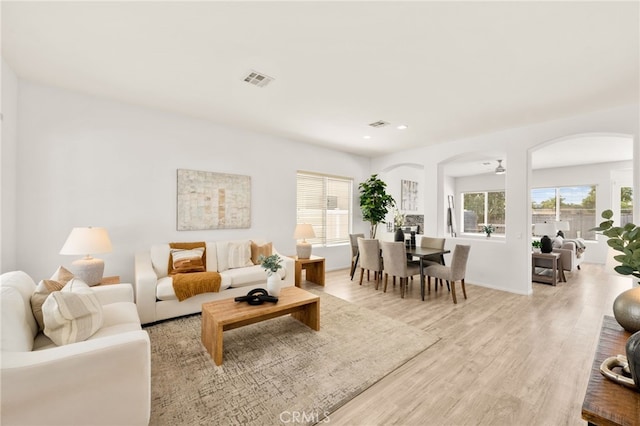 40065 Temple Ct, Murrieta, CA 92563 - living room featuring arched walkways, light wood-style floors, healthy amount of natural light, and recessed lighting