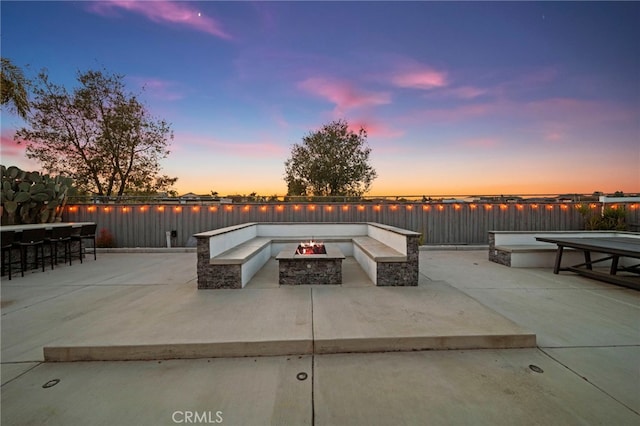 40065 Temple Ct, Murrieta, CA 92563 - patio terrace at dusk with an outdoor fire pit, a water view, and a patio