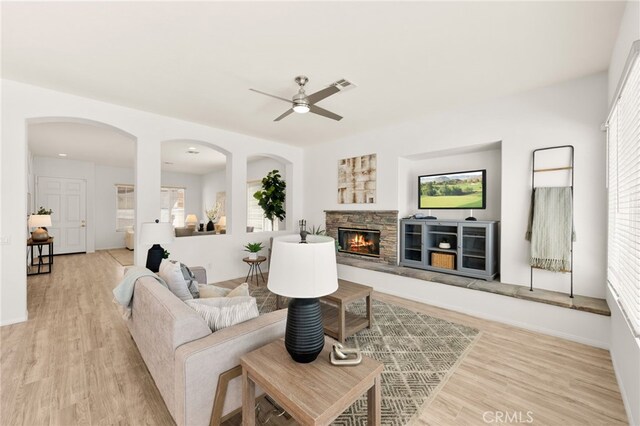 40065 Temple Ct, Murrieta, CA 92563 - living room with a ceiling fan, light wood finished floors, a fireplace, and healthy amount of natural light
