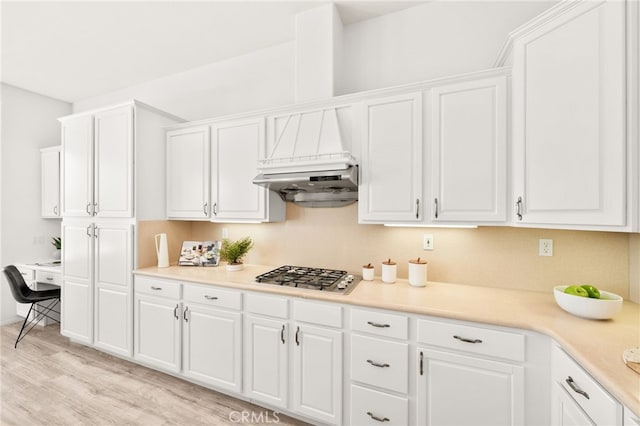 40065 Temple Ct, Murrieta, CA 92563 - kitchen featuring stainless steel gas stovetop, light wood-style flooring, white cabinetry, built in desk, and light countertops