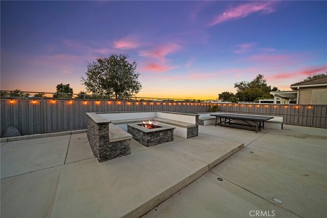 40065 Temple Ct, Murrieta, CA 92563 - patio terrace at dusk with a fire pit, a patio area, and a water view