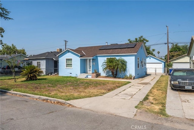 7086 Fairfax Dr, San Bernardino, CA 92404 - view of front facade featuring stucco siding, solar panels, a garage, and a shingled roof