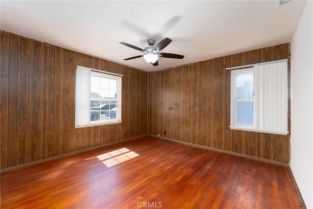 7086 Fairfax Dr, San Bernardino, CA 92404 - empty room featuring wood finished floors, ceiling fan, and wooden walls