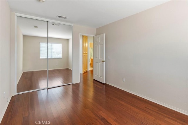 6879 Mission Grove Pkwy N, Riverside, CA 92506 - unfurnished bedroom featuring wood finished floors and a closet