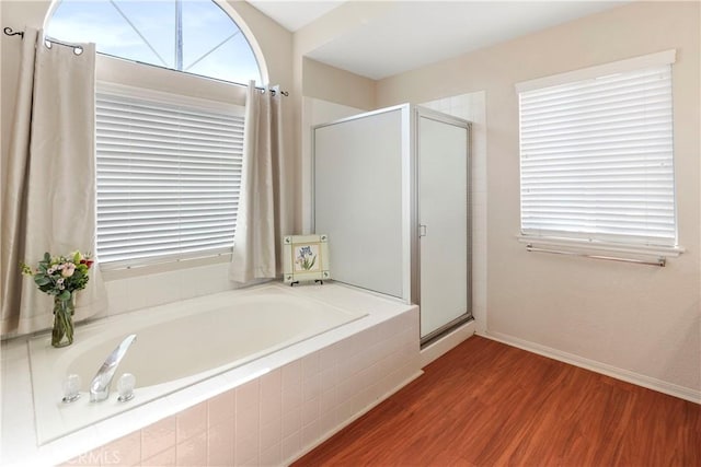 6879 Mission Grove Pkwy N, Riverside, CA 92506 - bathroom featuring a shower stall, a garden tub, wood finished floors, and plenty of natural light