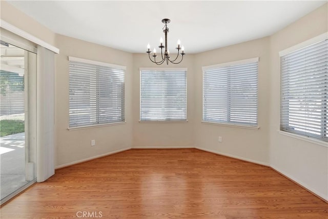6879 Mission Grove Pkwy N, Riverside, CA 92506 - unfurnished dining area with a chandelier and light wood-type flooring