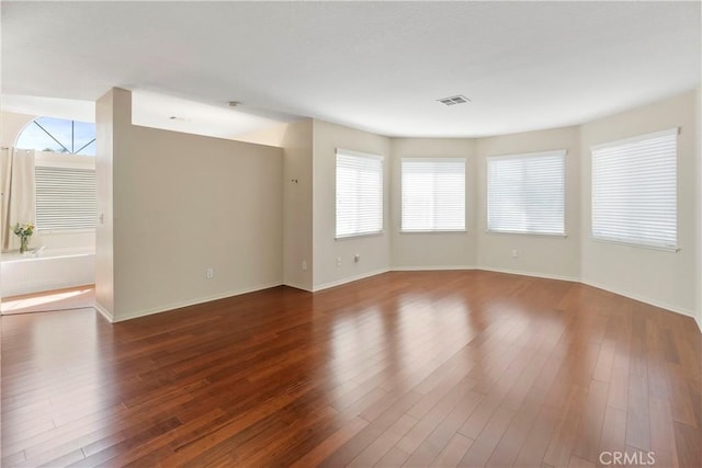 6879 Mission Grove Pkwy N, Riverside, CA 92506 - spare room featuring plenty of natural light and hardwood / wood-style flooring