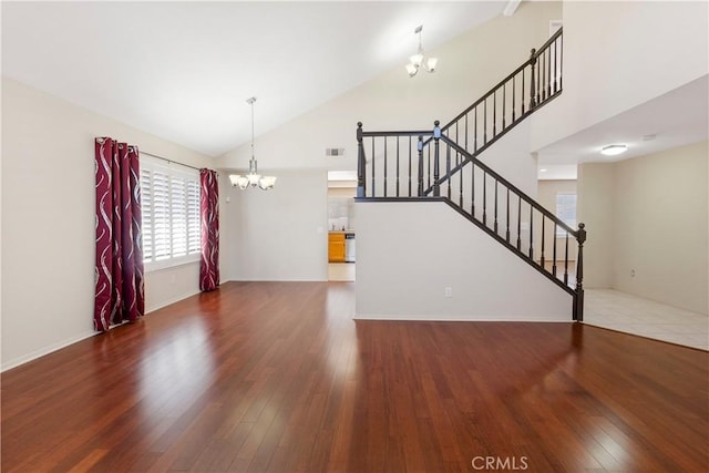 6879 Mission Grove Pkwy N, Riverside, CA 92506 - unfurnished living room with a chandelier, high vaulted ceiling, wood finished floors, and stairway