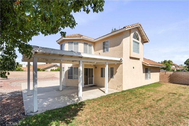 6879 Mission Grove Pkwy N, Riverside, CA 92506 - back of property with stucco siding, a fenced backyard, a patio area, and a tile roof