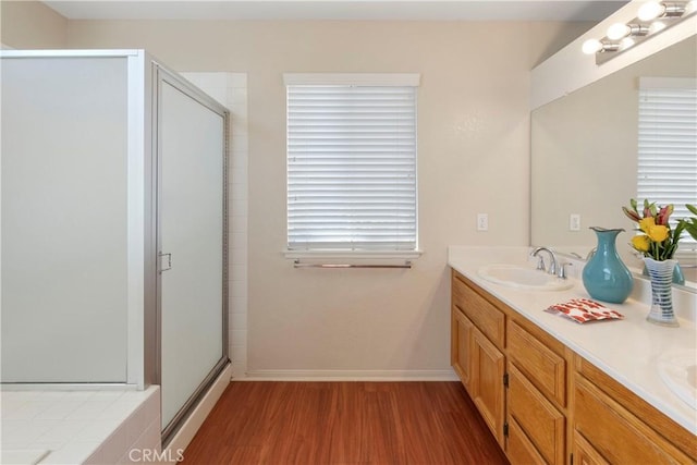6879 Mission Grove Pkwy N, Riverside, CA 92506 - bathroom featuring wood finished floors, a shower stall, and double vanity
