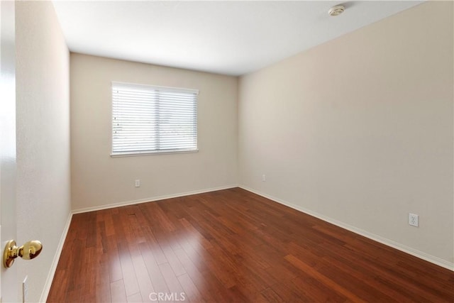 6879 Mission Grove Pkwy N, Riverside, CA 92506 - unfurnished room with a smoke detector and dark wood-type flooring