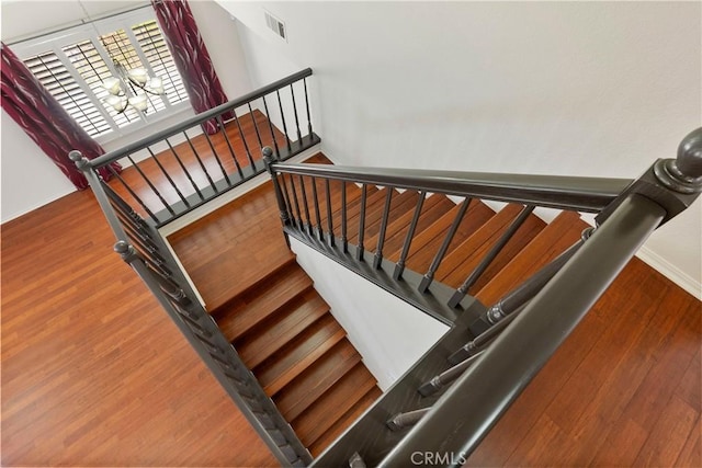 6879 Mission Grove Pkwy N, Riverside, CA 92506 - stairway with wood finished floors and baseboards