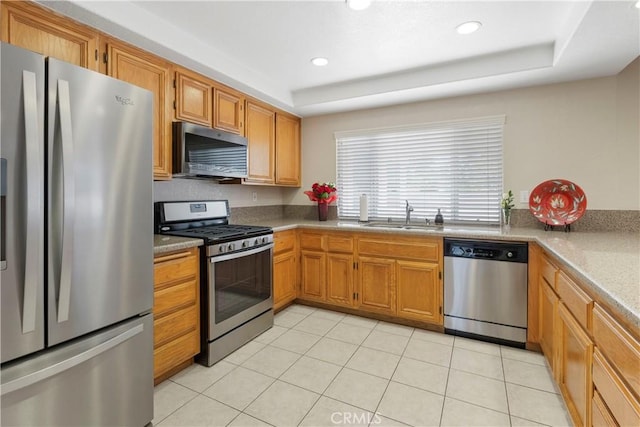 6879 Mission Grove Pkwy N, Riverside, CA 92506 - kitchen featuring stainless steel appliances, recessed lighting, light countertops, a raised ceiling, and brown cabinets